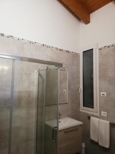 a bathroom with a shower and a sink and a mirror at Agriturismo N'Uova Campagna in Bologna