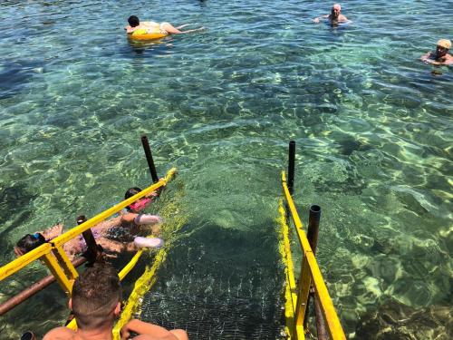 eine Gruppe von Menschen, die im Wasser schwimmen in der Unterkunft Populus in Syrakus