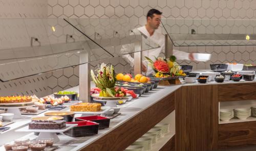 a chef in a kitchen preparing a buffet of food at Golden Costa Salou - Adults Only 4* Sup in Salou