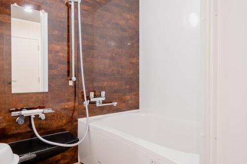 a bathroom with a sink and a mirror at Hotel Pagoda in Nara