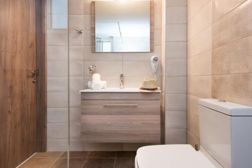 a bathroom with a sink and a mirror at Kristi Apartments in Hersonissos