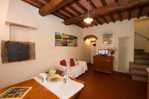 ein Wohnzimmer mit einem Sofa und einem Tisch in der Unterkunft I Gelsi in Figline Valdarno