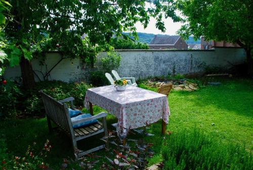 a table with a vase on it in a yard at Staying with the artist in Teuven