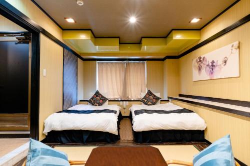 Giường trong phòng chung tại Hotel Pagoda