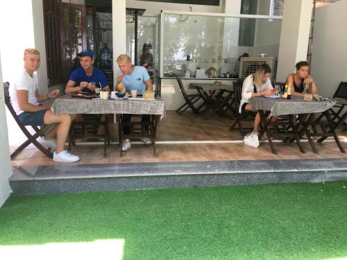 a group of people sitting at tables in a restaurant at Hana Riverside Villa in Quang Ngai