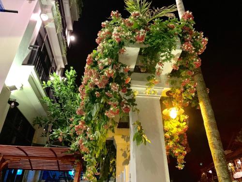 a cross decorated with flowers on a building at Santa Sea Villa in Hoi An