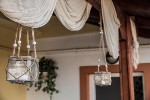 two lights hanging from the ceiling of a room at Arena's Place in Tympáki