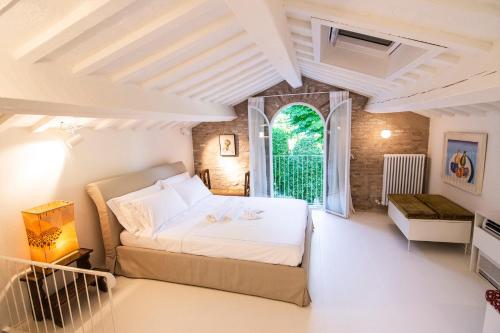 a bedroom with a bed and a window at DelleFarfalle Boutique B&B in Santarcangelo di Romagna