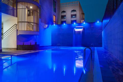 a swimming pool with blue lights in a building at Kn Aparthotel Columbus in Playa de las Americas
