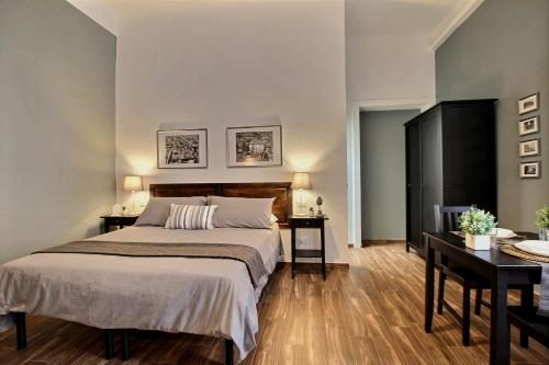 a bedroom with a large bed and two tables at La Ca' di sogn in Pavia