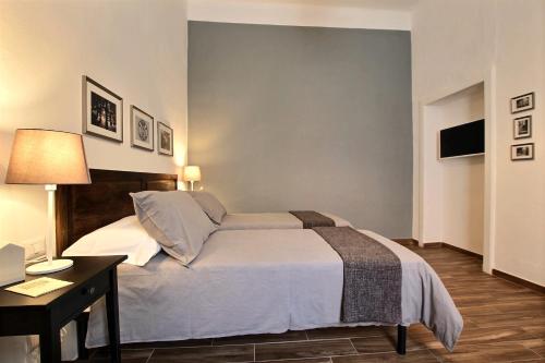 a bedroom with a bed and a desk and a television at La Ca' di sogn in Pavia