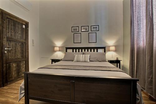 a bedroom with a large bed and two tables at La Ca' di sogn in Pavia