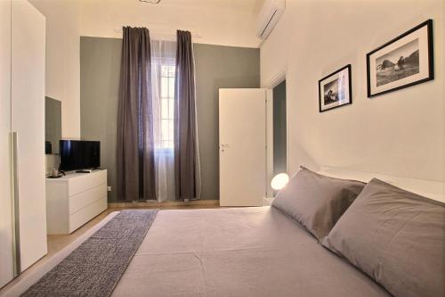 a bedroom with a bed and a television in it at La Ca' di sogn in Pavia