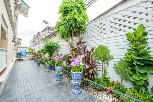 a row of plants in blue and white vases at The Orchid House 153 in Bangkok