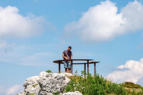 a man standing on top of a building on a hill at Albergo Rifugio Graziani in Brentonico