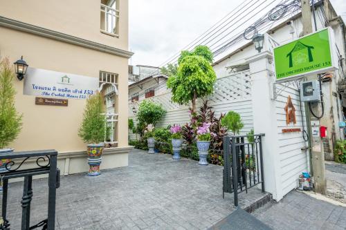 a building with potted plants on the side of it at The Orchid House 153 in Bangkok