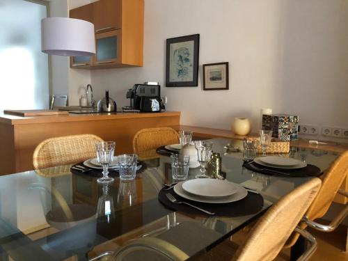 a dining room with a table with chairs and a kitchen at Diana 16 in Denia
