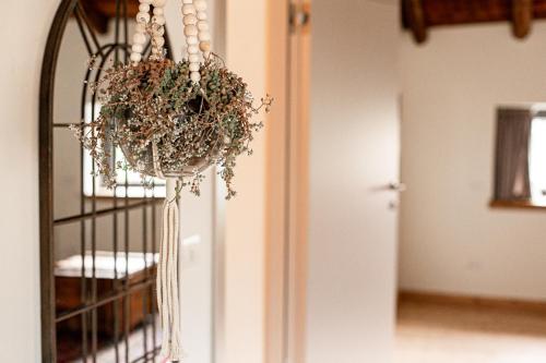a potted plant hanging from a wrought iron gate at foresteria stazzona in Villa di Tirano