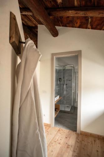 a wedding dress hanging on a wall in a room at foresteria stazzona in Villa di Tirano