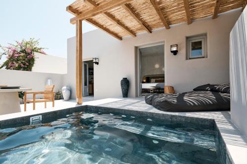 a swimming pool in the middle of a house at Marillia Village in Perivolos