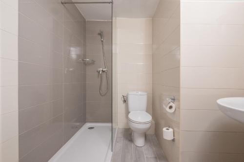 y baño con ducha, aseo y lavamanos. en azuLine Hotel Llevant, en San Antonio