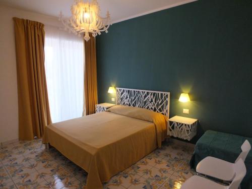 Säng eller sängar i ett rum på Casa Vacanze Baia Garagliano