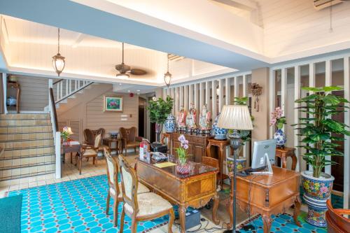 a living room with a table and chairs at The Orchid House 153 in Bangkok