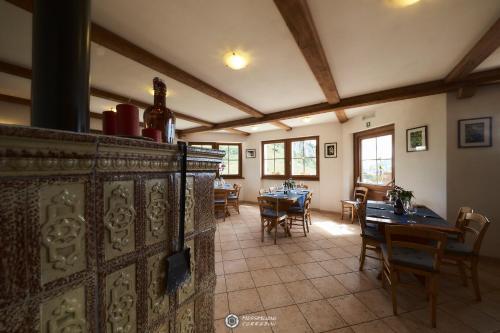 a dining room with tables and chairs in a building at Albergo Rifugio Graziani in Brentonico