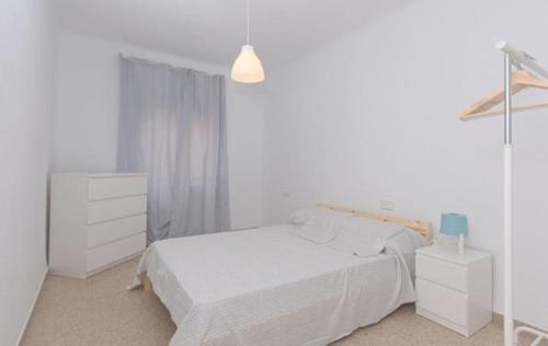 1 dormitorio blanco con 1 cama y vestidor en APARTAMENTO VISTABELLA, en Murcia