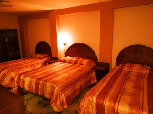 Ліжко або ліжка в номері Hostal Estrellita Dorada