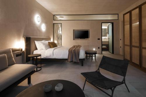 a hotel room with a bed and a couch at Marillia Village in Perivolos