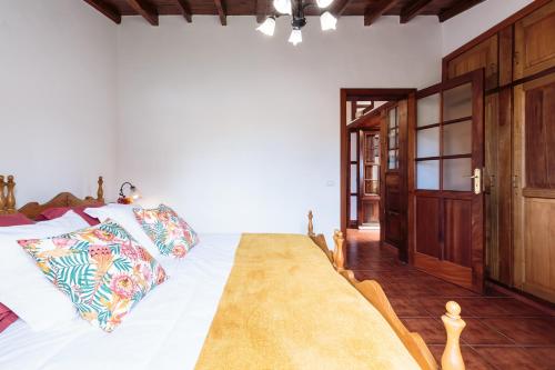 a bedroom with a large bed with white sheets at Rúbel in Villa de Mazo