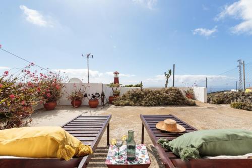 a patio with two sets of chairs and a table at Rúbel in Villa de Mazo