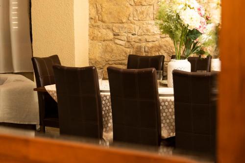 a group of chairs sitting at a table with flowers at Salamiou Stone House in Paphos City