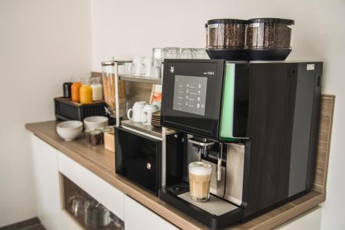 a coffee machine on a counter in a kitchen at Hayta Hotel Stuttgart Airport Messe in Filderstadt