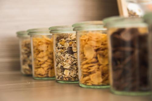 a group of jars filled with nuts and seeds at Hayta Hotel Stuttgart Airport Messe in Filderstadt