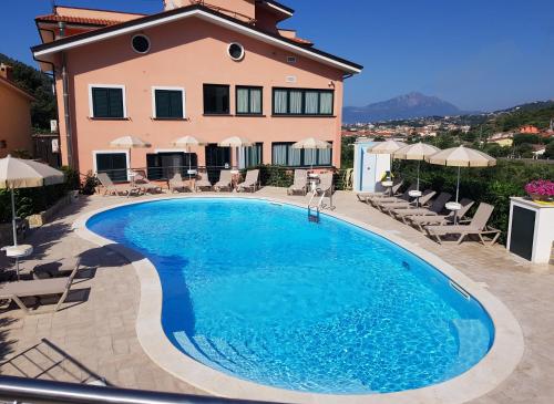 a large swimming pool in front of a house at Residence Gli Ulivi di Eolo in Sapri