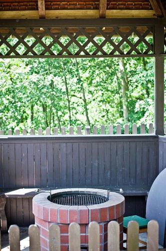 a patio with a fire pit with chairs around it at Willa ,, Krokus" in Ciche