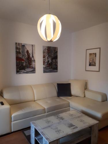 a living room with a couch and a coffee table at City Pension Zwickau in Zwickau