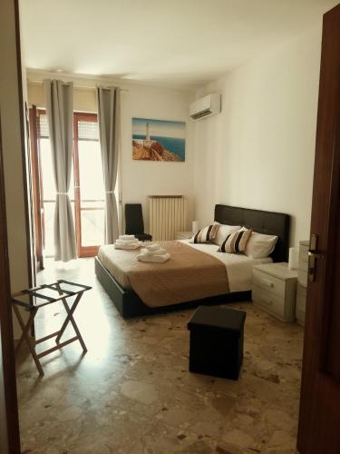 a bedroom with a bed and a table in it at Rosita Rooms in Lecce