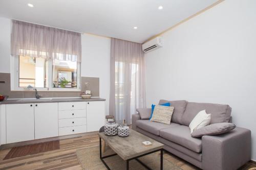 a living room with a couch and a table at Elenis Philoxenia in Ixia
