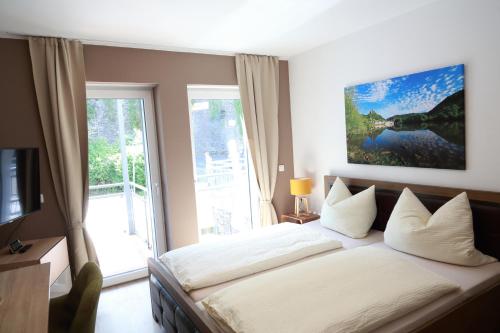 a bedroom with a bed and a large window at Feriendomizil Zur Burg in Cochem