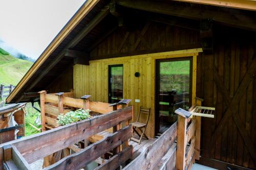 a log cabin with a porch and a door at Innertrein in Cadipietra