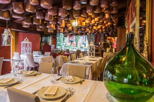 a green bottle sitting on a table in a restaurant at Locanda Da Lino in Pieve di Soligo