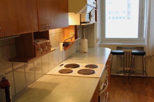 a kitchen with a stove and a counter top at Apartment Widbominkulma in Pori