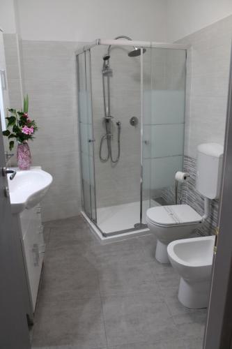 a bathroom with a shower and a toilet and a sink at Appartamenti Borghetto San Donato 105 in Bologna