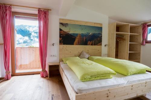 a bedroom with a bed and a large window at Innertrein in Cadipietra