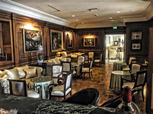 a restaurant with tables and chairs in a room at Excelsior Palace Portofino Coast in Rapallo