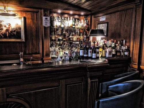 a bar with a lot of bottles of alcohol at Excelsior Palace Portofino Coast in Rapallo