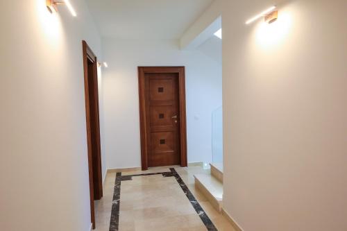 a hallway with a door and a tile floor at Villa Horus in Sveti Stefan